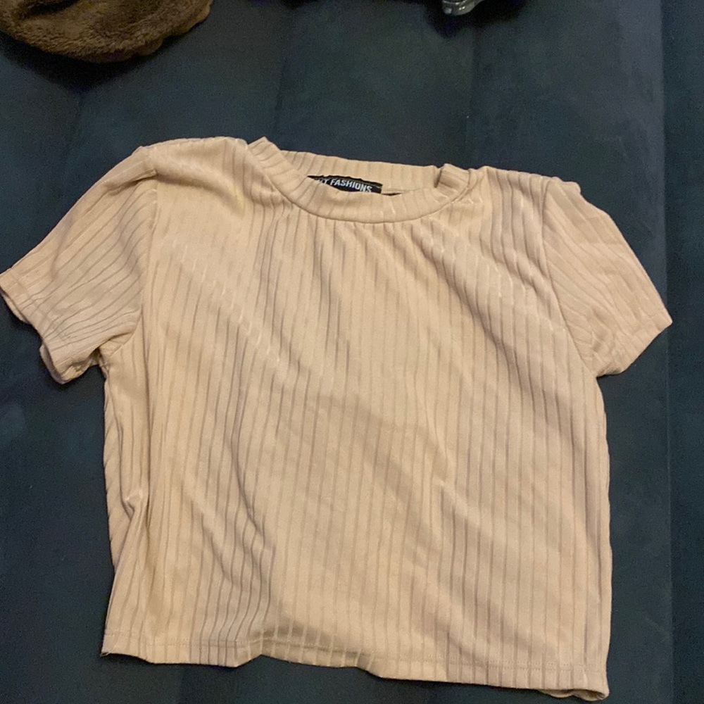 Cream colored Crop top with cinched hole on back.